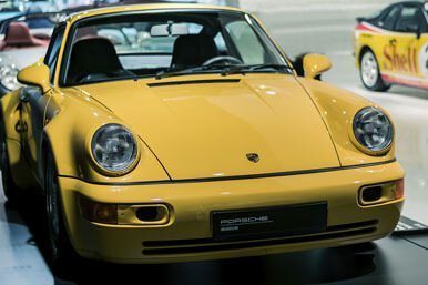 A close-up shot of a yellow Porsche front end view.